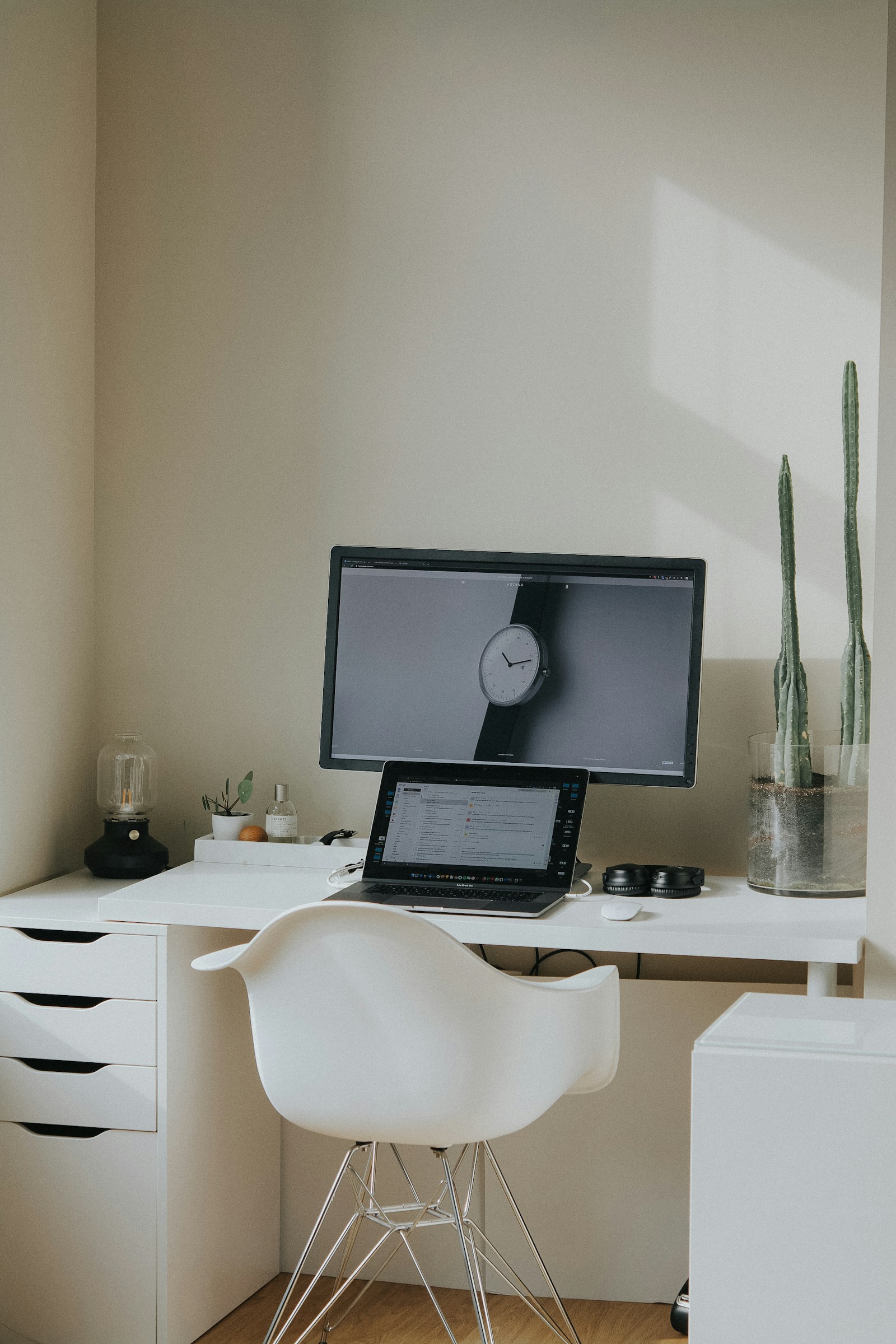 A minimalist desk with a laptop and monitor